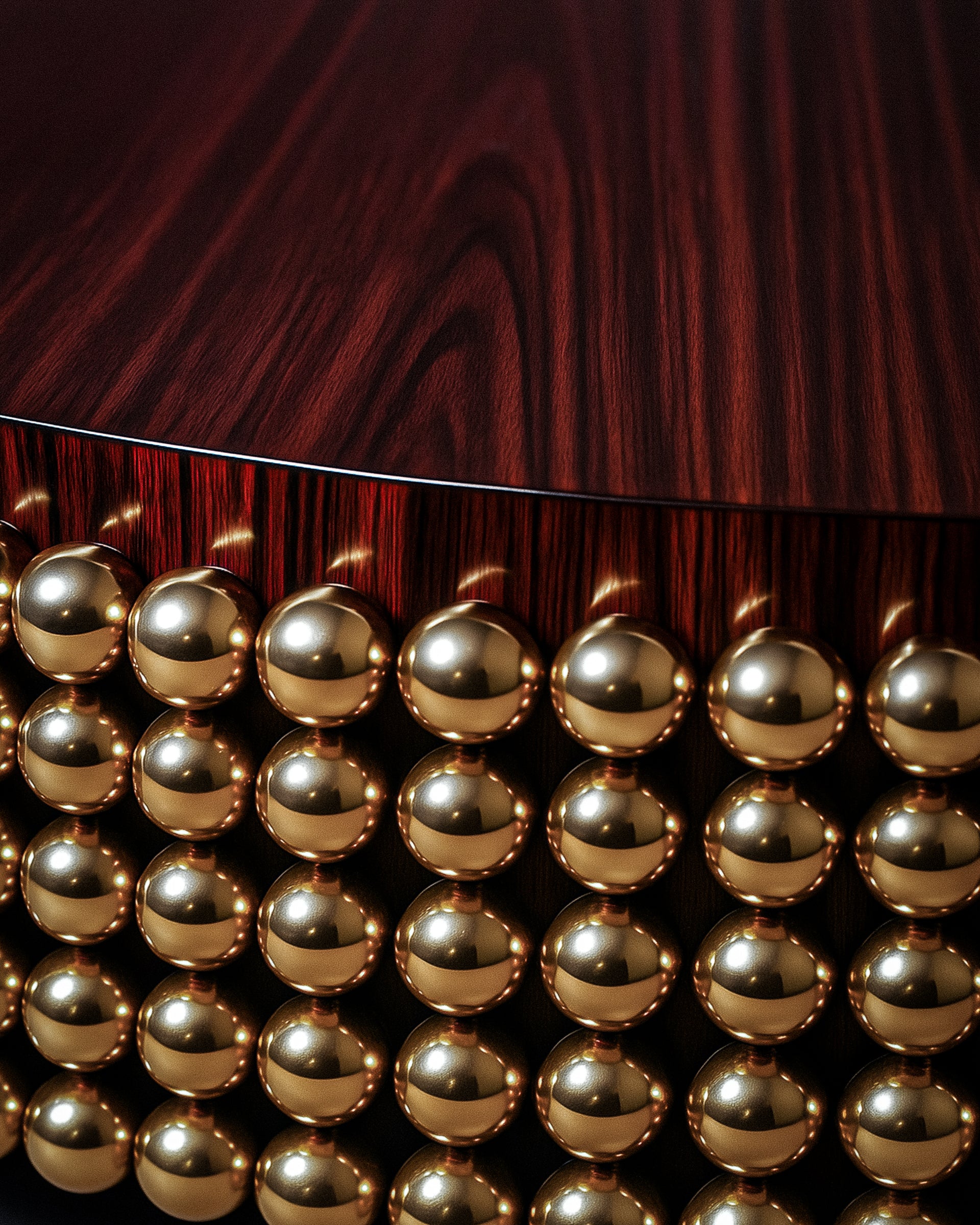Close-up of polished gold-plated stainless-steel spheres under Lustra Coffee Table.